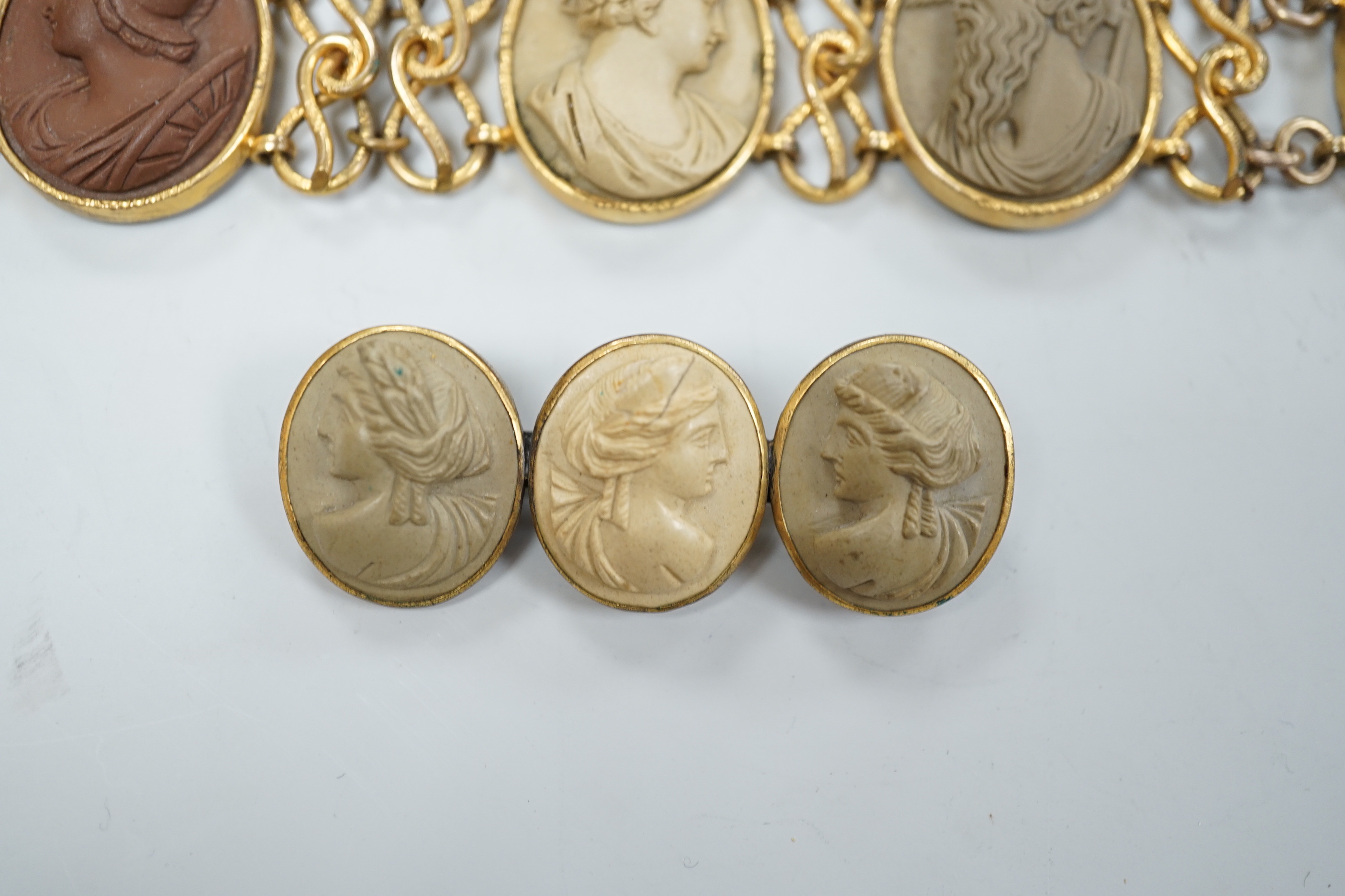 A 19th century gilt metal and oval lava panel set bracelet, 16.8cm and a similar brooch.